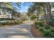 Serene community walking path lined with lush greenery and mature trees at 415 Ocean Creek Dr. # 2145, Myrtle Beach, SC 29572