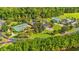 Beautiful aerial view featuring the pool, playground, and tennis courts within lush greenery at 4165 Eva Bay Dr., Murrells Inlet, SC 29576