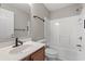 The bathroom is complete with a mirror, toilet, sink and a tub and shower with white tile surround at 4165 Eva Bay Dr., Murrells Inlet, SC 29576