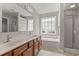 Well-lit bathroom with double sink vanity, large tub, and glass shower at 4165 Eva Bay Dr., Murrells Inlet, SC 29576
