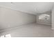 This bonus room has neutral paint, carpet, and access to a fan in an adjacent room at 4165 Eva Bay Dr., Murrells Inlet, SC 29576