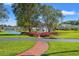 This is the community gazebo that is surrounded by water, flowers, and green grass at 4165 Eva Bay Dr., Murrells Inlet, SC 29576