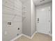 Practical laundry room with wire shelving and tile flooring at 4165 Eva Bay Dr., Murrells Inlet, SC 29576