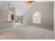 Bright open-concept living room with vaulted ceilings, carpet, and natural light at 4165 Eva Bay Dr., Murrells Inlet, SC 29576