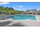 Community pool with lounge chairs and covered area, surrounded by palm trees and well-maintained grounds at 4165 Eva Bay Dr., Murrells Inlet, SC 29576