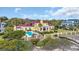 Aerial view of a large home with a pool, manicured lawns, and beach access with many mature trees at 4204 N Ocean Blvd., Myrtle Beach, SC 29577