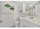 Cozy bathroom with decorative fish wall art, tiled floors, and white vanity with overhead cabinet at 4204 N Ocean Blvd., Myrtle Beach, SC 29577