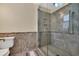 Modern bathroom with a glass-enclosed shower, tiled walls, and neutral color scheme at 4204 N Ocean Blvd., Myrtle Beach, SC 29577
