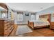Spacious bedroom with hardwood floors, a wooden bed frame, and dresser, with natural lighting at 4204 N Ocean Blvd., Myrtle Beach, SC 29577