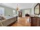 Bright bedroom with hardwood floors, wooden furniture, and natural light from shuttered windows at 4204 N Ocean Blvd., Myrtle Beach, SC 29577