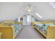 Bright, spacious bedroom featuring two twin beds, carpet flooring, and skylights for natural light at 4204 N Ocean Blvd., Myrtle Beach, SC 29577