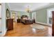 Comfortable bedroom featuring wooden furniture, hardwood floors, and natural light from the window at 4204 N Ocean Blvd., Myrtle Beach, SC 29577