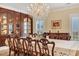 Bright dining room with hardwood flooring, chandelier, and backyard view at 4204 N Ocean Blvd., Myrtle Beach, SC 29577