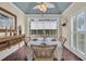Charming dining area with wicker chairs, round table, and natural light from windows with white shutters at 4204 N Ocean Blvd., Myrtle Beach, SC 29577