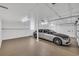 Clean, spacious garage featuring a modern vehicle with epoxy flooring and white painted walls and ceiling at 4204 N Ocean Blvd., Myrtle Beach, SC 29577