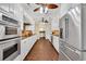 Spacious galley kitchen with white cabinetry, stainless steel appliances, and unique terracotta-colored tile floors at 4204 N Ocean Blvd., Myrtle Beach, SC 29577