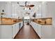 Galley kitchen with white cabinets, tiled backsplash, and stainless steel appliances at 4204 N Ocean Blvd., Myrtle Beach, SC 29577