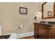 Elegant powder room with dark wood vanity and framed mirror at 4204 N Ocean Blvd., Myrtle Beach, SC 29577