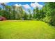 Expansive green backyard with a storage shed, offering plenty of space for recreation and gardening at 4391 Party Pines Rd., Conway, SC 29526