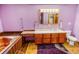 Colorful bathroom with wood-look flooring, a vanity with storage, and a soaking tub at 4391 Party Pines Rd., Conway, SC 29526