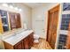 Well-lit bathroom featuring a dark wood vanity, neutral walls, and herringbone floors at 4391 Party Pines Rd., Conway, SC 29526