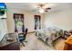 Cozy bedroom featuring neutral walls, a ceiling fan, a television, and bright, natural light at 4391 Party Pines Rd., Conway, SC 29526
