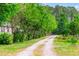 Long driveway lined with mature trees, creating a private entrance to the property at 4391 Party Pines Rd., Conway, SC 29526