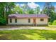 Charming single-story home with a welcoming orange front door and a well-maintained yard at 4391 Party Pines Rd., Conway, SC 29526