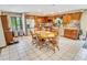 Bright eat-in kitchen with wooden cabinetry, stainless appliances, and a large dining table at 4391 Party Pines Rd., Conway, SC 29526