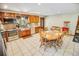 Spacious eat-in kitchen featuring stainless steel appliances, tile floors, and a wooden dining table at 4391 Party Pines Rd., Conway, SC 29526