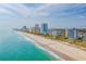 Aerial view of the beachfront featuring modern resorts and hotels along the coastline, offering stunning ocean views at 4425 Honir Dr., Myrtle Beach, SC 29579