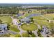 Aerial view of a golf course and community clubhouse with lush green fairways, water features, and manicured landscapes at 4425 Honir Dr., Myrtle Beach, SC 29579