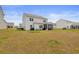 View of the backyard featuring a spacious yard and screened patio with a peaceful residential view at 4425 Honir Dr., Myrtle Beach, SC 29579