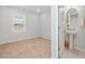 Bright bedroom adjacent to the powder room with carpet flooring and a window at 4425 Honir Dr., Myrtle Beach, SC 29579