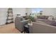 Comfortable living room featuring plush seating, a functional workspace, and an abundance of natural light at 4425 Honir Dr., Myrtle Beach, SC 29579
