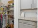 Organized pantry with wire shelving and gray cabinets next to a granite countertop at 4425 Honir Dr., Myrtle Beach, SC 29579