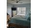 Bedroom features a natural wooden bed frame, soft bedding, side tables, and coastal-themed decor at 4449 Turtle Ln. # 3A, Little River, SC 29566