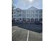 Beautiful three-story condo building with a parking lot and covered balconies at 4449 Turtle Ln. # 3A, Little River, SC 29566
