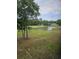 Scenic golf course view with lush green fairways, mature trees, and a tranquil pond at 4449 Turtle Ln. # 3A, Little River, SC 29566