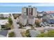 Aerial view of a condo in close proximity to the beach, with other houses and a tall condo in the background at 4500 S Ocean Blvd. # 4, North Myrtle Beach, SC 29582