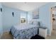 Cozy bedroom with nautical decor, blue walls, and natural light at 4500 S Ocean Blvd. # 4, North Myrtle Beach, SC 29582