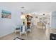 Open-concept dining area features a glass table, seating for four, and flows into the kitchen at 4500 S Ocean Blvd. # 4, North Myrtle Beach, SC 29582