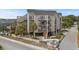 Three-story condo building with multiple balconies and covered parking, surrounded by lush landscaping and street access at 4500 S Ocean Blvd. # 4, North Myrtle Beach, SC 29582