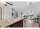 Open-concept kitchen with tiled countertops and an island with sink that overlooks living space and deck at 4500 S Ocean Blvd. # 4, North Myrtle Beach, SC 29582