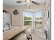 Kitchen area with tiled island countertops and window overlooking outdoor scenery and stackable laundry units at 4500 S Ocean Blvd. # 4, North Myrtle Beach, SC 29582