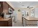 Open kitchen with tile countertops, modern appliances, a sunlit window, and an island with barstool seating at 4500 S Ocean Blvd. # 4, North Myrtle Beach, SC 29582