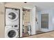 Efficient laundry area features a stacked washer and dryer plus an open pantry-style closet for storage at 4500 S Ocean Blvd. # 4, North Myrtle Beach, SC 29582