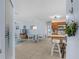 Open-concept living room and kitchen area with tiled floors, light blue walls, and modern furnishings at 4500 S Ocean Blvd. # 4, North Myrtle Beach, SC 29582