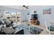Cozy living room with a black leather sofa, starfish rug, and a balcony view through the sliding glass doors at 4500 S Ocean Blvd. # 4, North Myrtle Beach, SC 29582