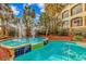 A gorgeous pool area with dolphin decor, fountains and lush landscaping next to the building at 4800 S Ocean Blvd. # 1402, North Myrtle Beach, SC 29582